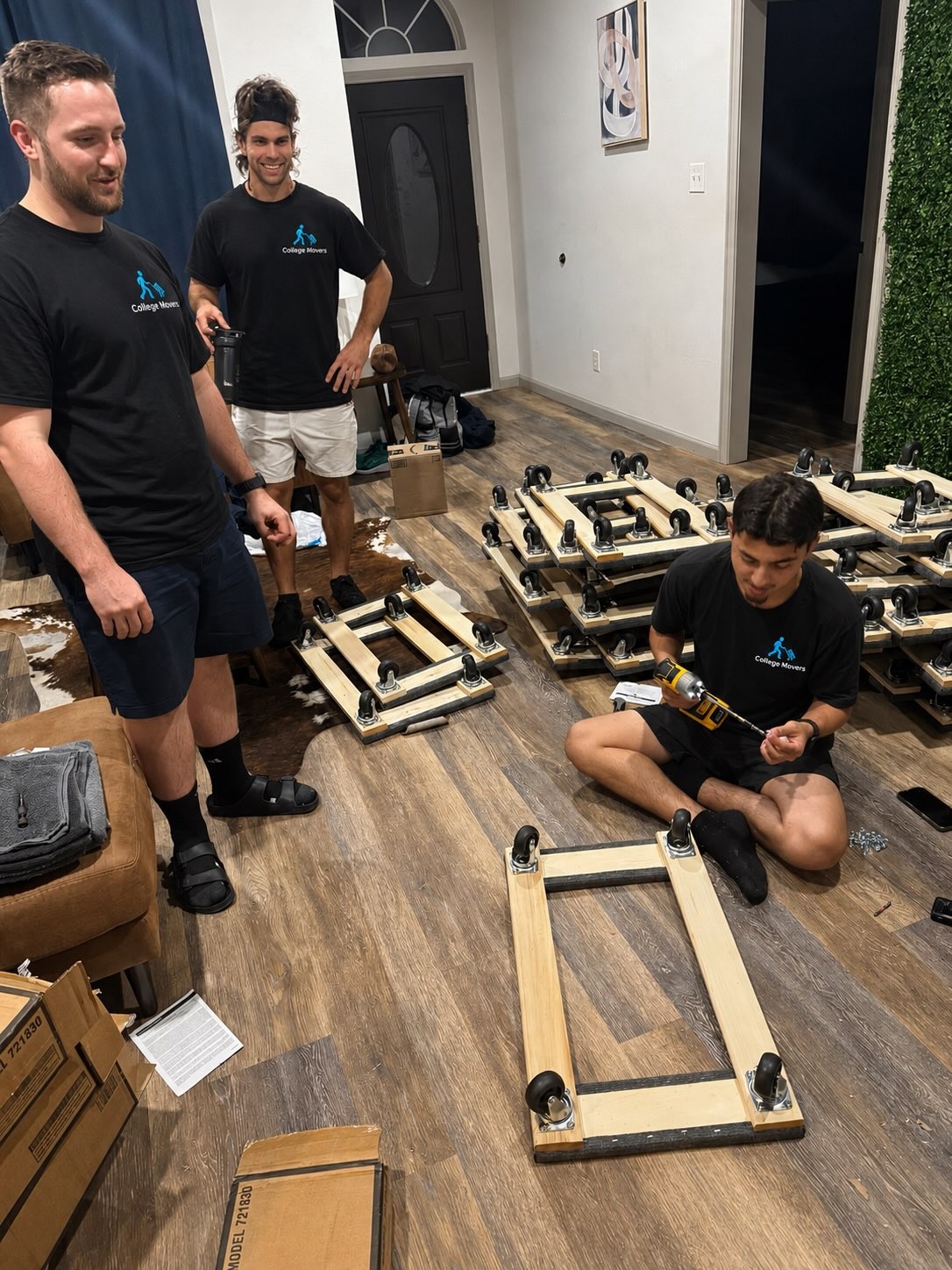 College Movers crew assembling furniture