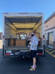 College Movers team member with furniture inside a moving truck