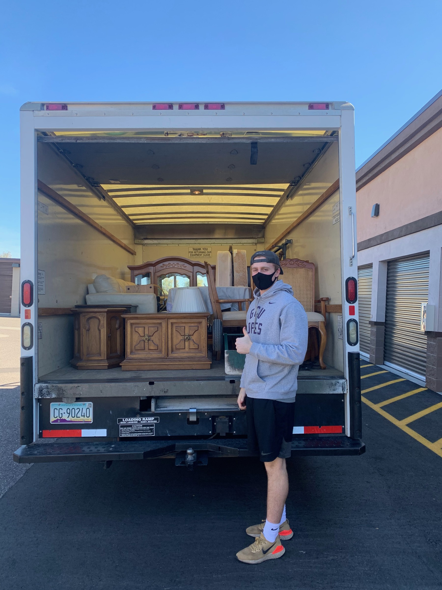 College Movers team member with furniture inside a moving truck