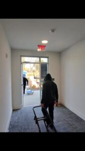 College Movers team member in an empty apartment