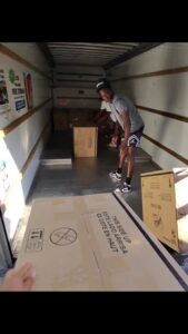College Movers team member inside a moving truck