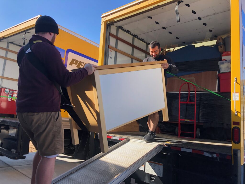 College Movers crew loading a cabinet