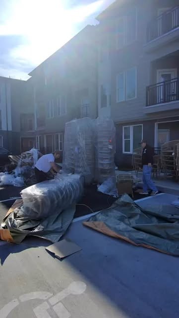 Wrapped furniture staged outside an apartment for moving